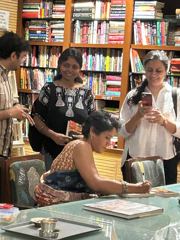 Nitya signing books for readers